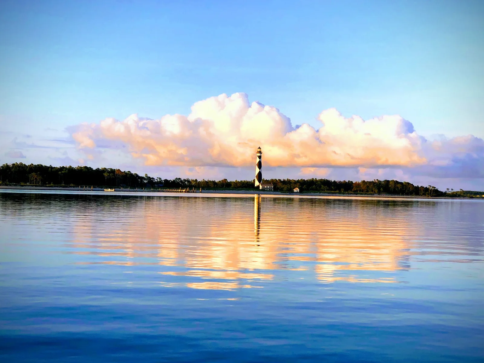 Cape Lookout Lighthouse across the water at sunrise in June 2019, before current stabilization work