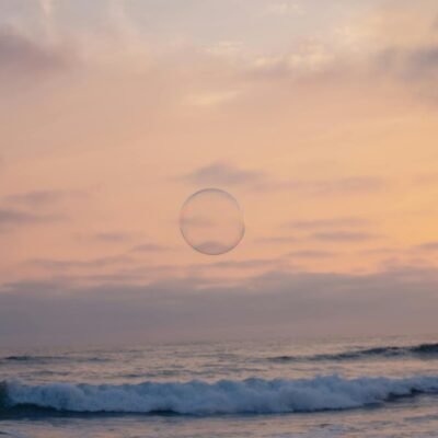 A bubble floating in the ocean at sunset