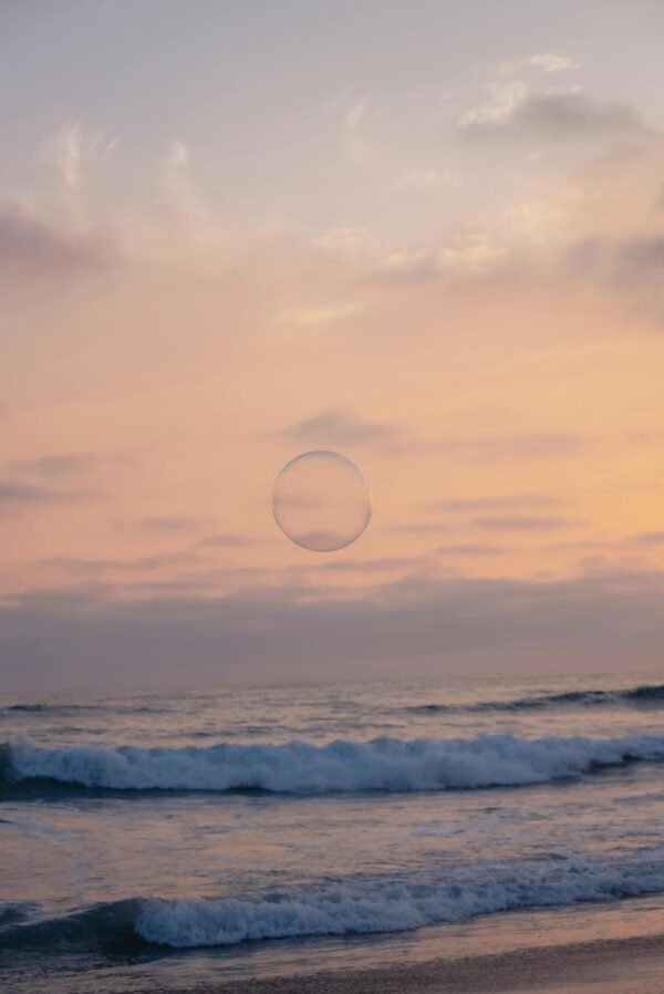 A bubble floating in the ocean at sunset